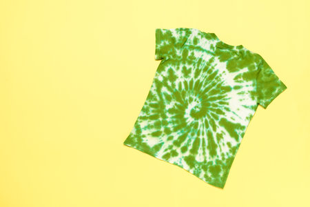 Green and White Tie-Dye T-Shirt on Yellow Background - Trendy, Fashionable Apparel Photographyの写真素材