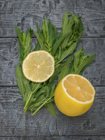 Freshly Cut Lemon with Mint Leaves on Rustic Wooden Background