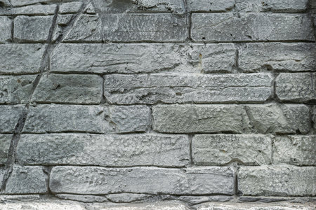 Old Stone Wall Texture with Weathered Gray Brick Pattern Suitable for Backgroundsの写真素材
