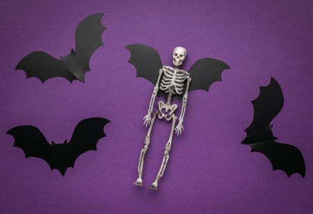 Halloween Skeleton with Bat Wings on Purple Backgroundの写真素材