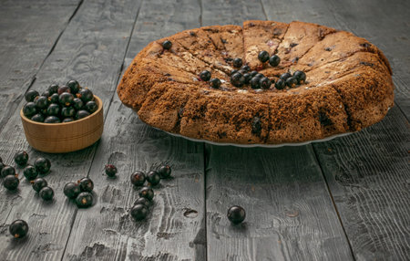 Homemade Blackcurrant Pie on Rustic Wooden Table with Fresh Berries in Bowlの写真素材