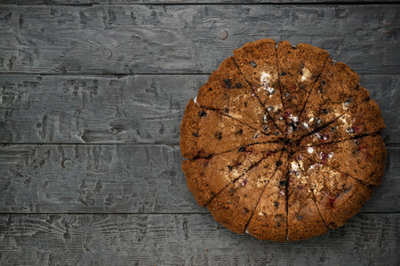 Rustic Berry Chocolate Chip Cookie Pie on Weathered Wooden Tableの写真素材