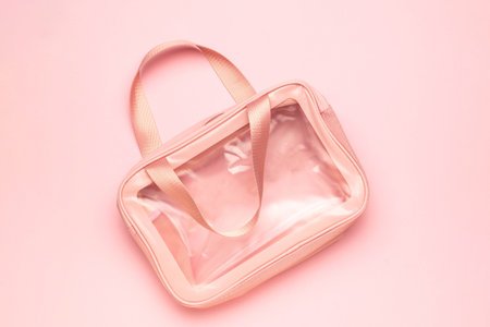 Transparent Pink Plastic Tote Bag on Light Pink Background: Trendy and Minimalist Fashion Accessoryの写真素材
