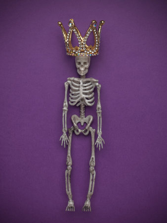 Skeleton Wearing a Crown on Purple Background - Spooky, Artistic Conceptの写真素材
