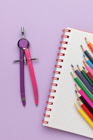 Colorful Drawing Tools: Vibrant Compasses and Graph Paper with Colored Pencils on Pastel Backgroundの写真素材