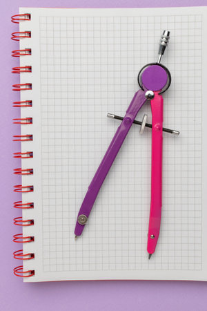 Geometric Drawing Tools: Colorful Compass on Graph Paper in Notebook for Math and Designの写真素材