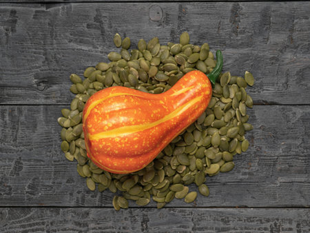 Gourd on Pumpkin Seeds Against Rustic Wooden Backgroundの写真素材