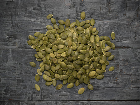 Healthy Raw Pumpkin Seeds on Rustic Dark Wooden Backgroundの写真素材