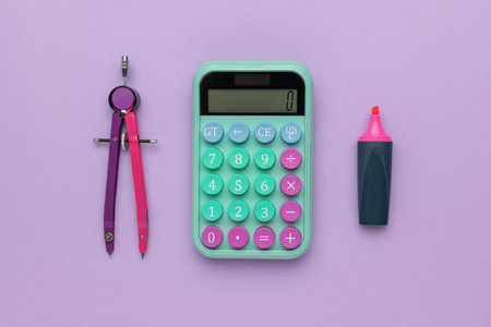 Colorful Geometry Tools and Calculator on Purple Background - School Supplies and Stationeryの写真素材