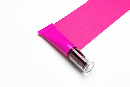 Pink Cosmetic Tube on White Surface with Vibrant Pink Background - Beauty and Skincare Conceptの写真素材