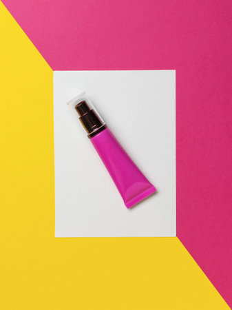 Pink Cosmetic Tube on Geometric Yellow and Pink Background - Skincare, Beauty, Minimalist Designの写真素材