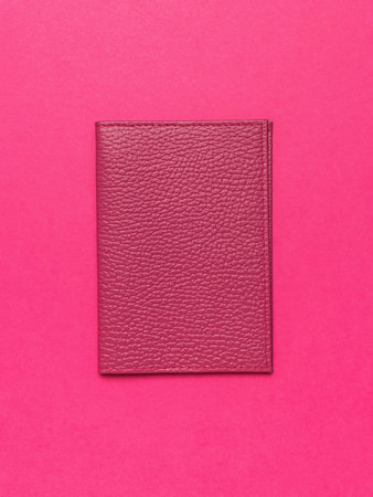 Top View of Pink Leather Wallet on Vibrant Pink Background - Minimalist and Stylish Accessoryの写真素材