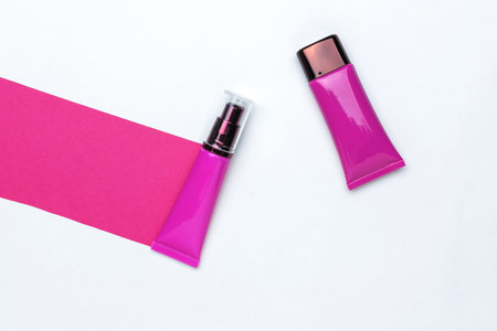 Two Pink Cosmetic Tubes with Minimalist Design on White Backgroundの写真素材