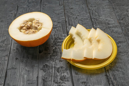 Freshly Cut Melon on Rustic Wooden Tableの写真素材
