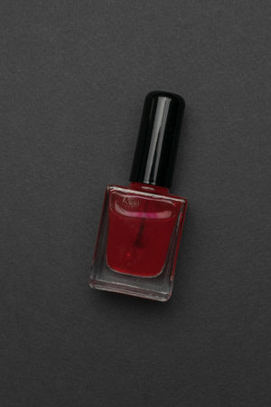 Red Nail Polish Bottle on Dark Gray Background - Beauty, Cosmetics, Manicure, Glamorの写真素材
