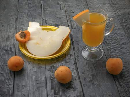 Refreshing Melon Juice with Apricots on Rustic Wooden Table - Healthy Summer Drink and Fruitsの写真素材