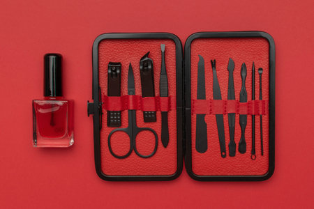 Manicure Set and Red Nail Polish Bottle on Red Backgroundの写真素材