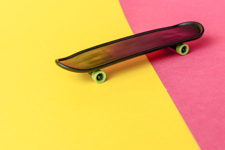 Minimalist Skateboard on Vibrant Yellow and Pink Background