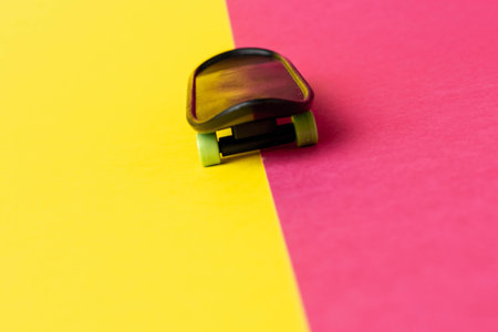 Miniature Skateboard on Colorful Yellow and Pink Backgroundの写真素材