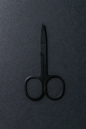 Minimalist Black Scissors on Dark Textured Background - Modern Tool Design for Creative Projectsの写真素材