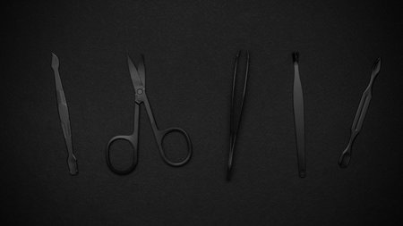 Black Surgical Instruments on Dark Background - Scalpel, Scissors, Tweezers, Extractorの写真素材
