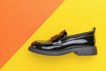 Black Patent Leather Loafer on Colorful Geometric Background - Fashion Footwear Close-Upの写真素材