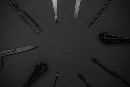Black Manicure and Pedicure Tools on Dark Background - Professional Grooming Equipmentの写真素材