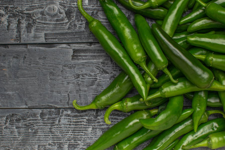 Fresh Green Chili Peppers on Rustic Wooden Table - Perfect for Culinary and Food Stock Photosの写真素材