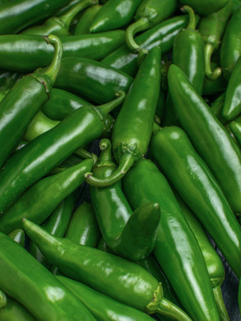Green hot chili peppers at the market. Shallow depth of field.の写真素材