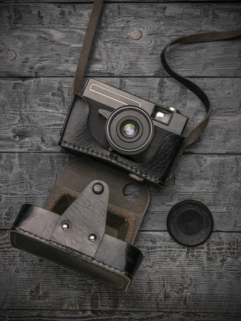 Vintage camera on wooden background. Top view with copy space.の写真素材