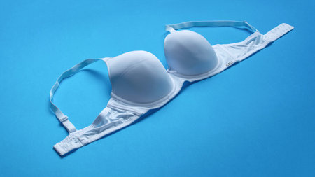 White bra on a blue background. Top view with copy space.の写真素材