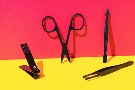 Colorful Background with Manicure Tools - Scissors, Nail Clipper, Cuticle Pusher, and Tweezersの写真素材