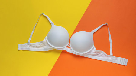 White Bra on Bright Yellow and Orange Background - Fashion, Lingerie, Colorful, Modernの写真素材