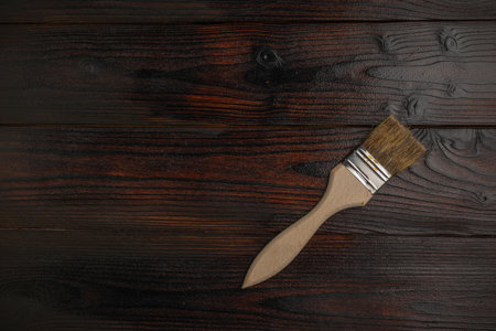 Rustic Wooden Background with Paintbrush: Dark Wood Texture for Artistic and DIY Projectsの写真素材