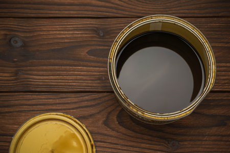 Open Paint Can on Dark Wooden Floor - Home Renovation and DIY Conceptの写真素材