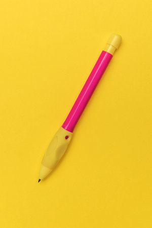 Bright Pink and Yellow Pen on Vibrant Yellow Background - Office Supplies, Stationery, Minimalist Designの写真素材