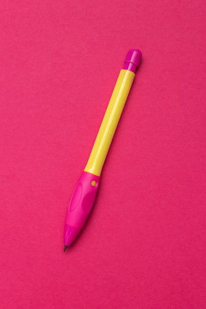 Bright Yellow and Pink Pen on Vibrant Red Surface - Office Supplies and School Stationeryの写真素材