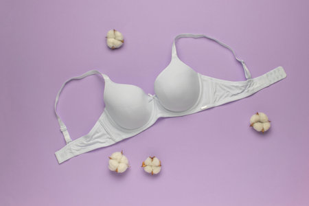 White Cotton Bra on Lavender Background with Cotton Flowers - Minimalist and Elegant Lingerie Conceptの写真素材