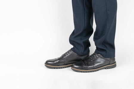 Business Professional Legs in Blue Pants and Black Shoes on White Backgroundの写真素材