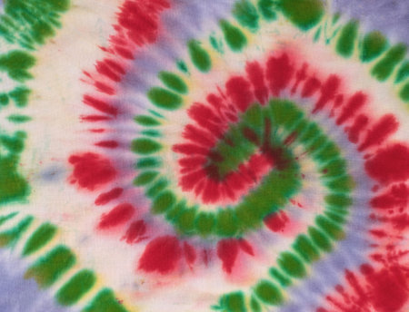 Colorful Spiral Tie-Dye Pattern with Red, Green, and Purple Swirlsの写真素材