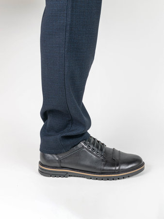 Businessman's Legs in Formal Pants with Black Leather Shoes on White Backgroundの写真素材