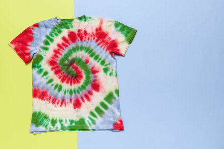 Colorful Tie-Dye T-Shirt on Vibrant Split Background - Trendy Fashion and Creative Clothing Designの写真素材