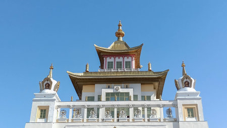 Stunning Buddhist Temple with Golden Roof Against Clear Blue Sky in Elista, Kalmykiaの写真素材
