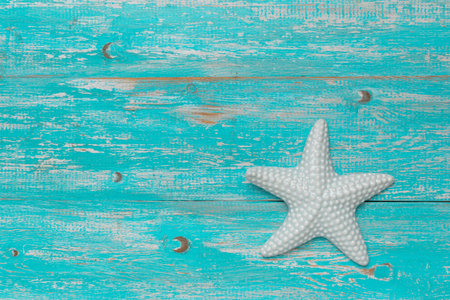 White Starfish on Turquoise Weathered Wooden Background: A Nautical and Summer Beach Themed Stock Photoの写真素材
