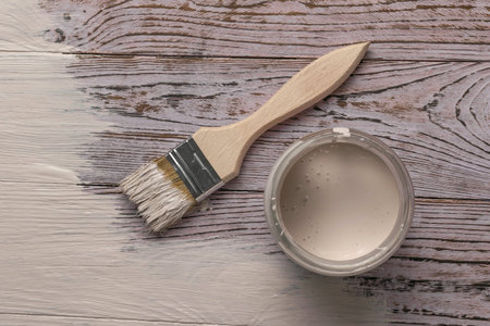 Painting a Wooden Surface with White Paint Using a Brush - Home Improvement and DIY Projectの写真素材