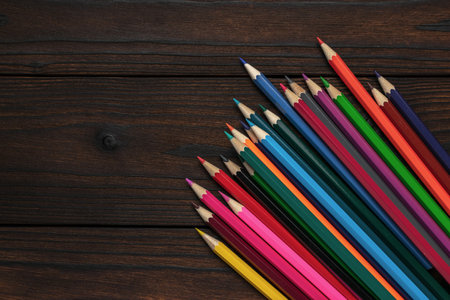 Colorful Pencils on Wooden Surface - Vibrant Art Supplies for Creative Projectsの写真素材