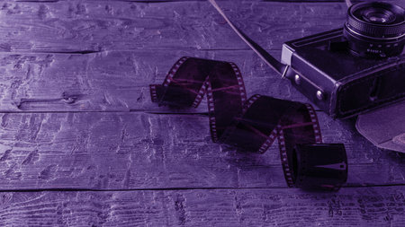 Vintage Camera and Film on Rustic Wooden Background - Retro Photography Conceptの写真素材