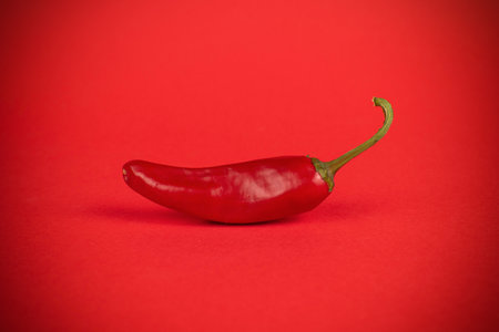 Vibrant Red Chili Pepper on Bold Red Background