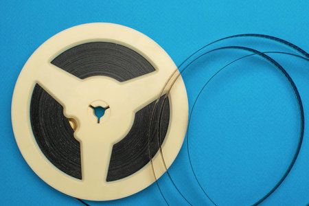 Vintage Film Reel on Vibrant Blue Background: Retro Cinema Concept