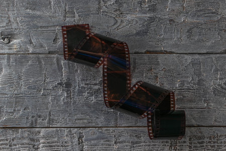 Vintage Film Reel on Rustic Wooden Background for Photography and Art Projects